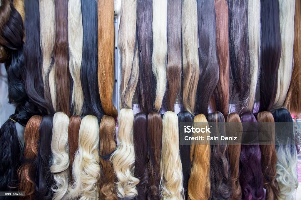Different color human hair extensions in wig shop
